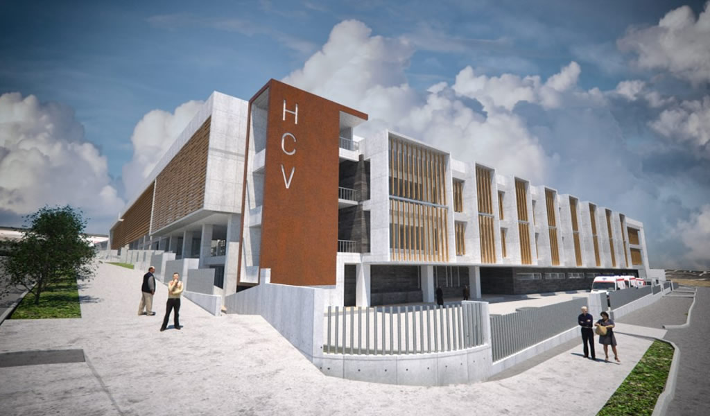 Render de un edificio de salud de tres pisos con fachada de hormigón, celosías de madera y una torre de acceso revestida en tono óxido